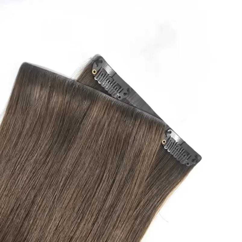 Clip-in brown hair extensions on a white background.