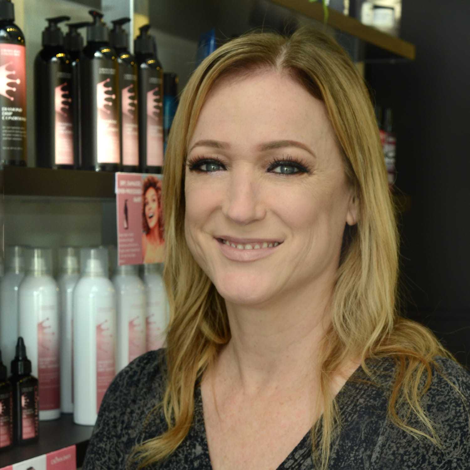 Portrait of Carly F., a professional stylist at Crown Envy, showcasing their expertise and style.