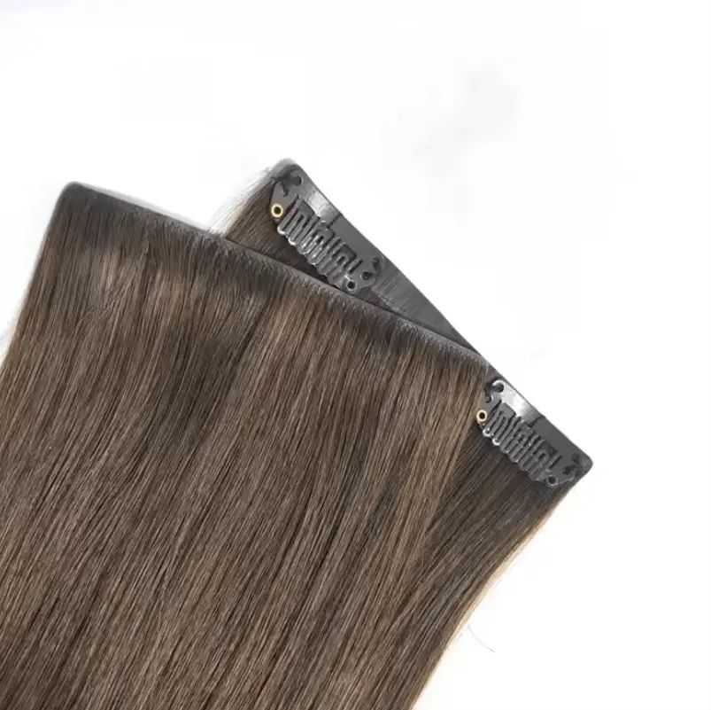 Clip-in brown hair extensions on a white background.